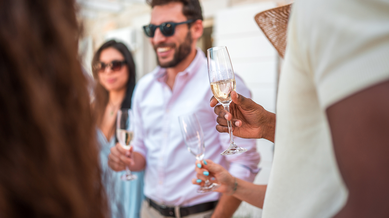 a group of people holding wine glasses
