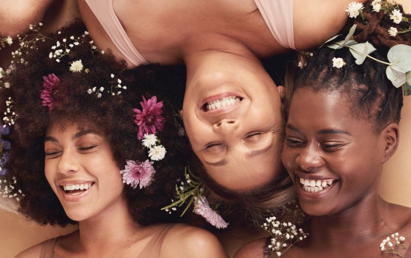 Image One Info a group of women lying down with flowers in their hair