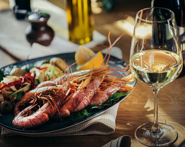 a plate of seafood and a glass of wine