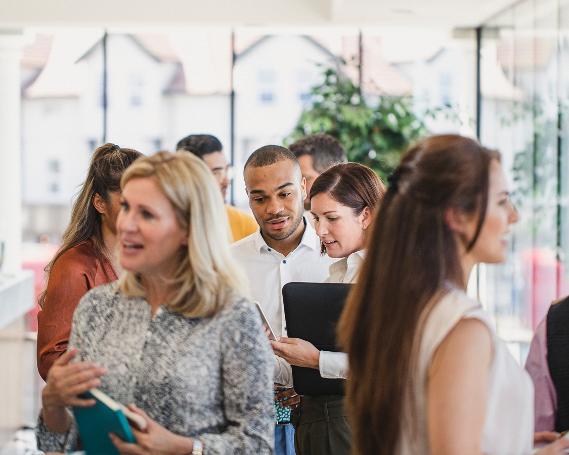 a group of people standing around a table