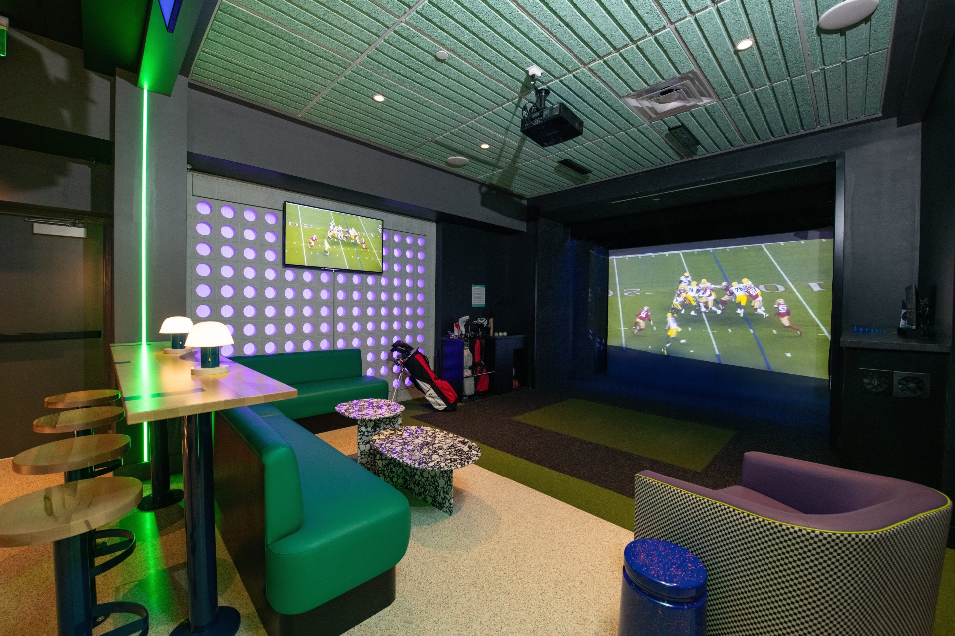 a room with a large screen and a television