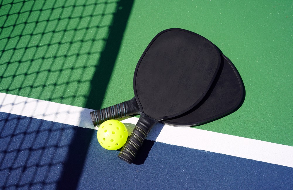 a tennis racket and ball on a table