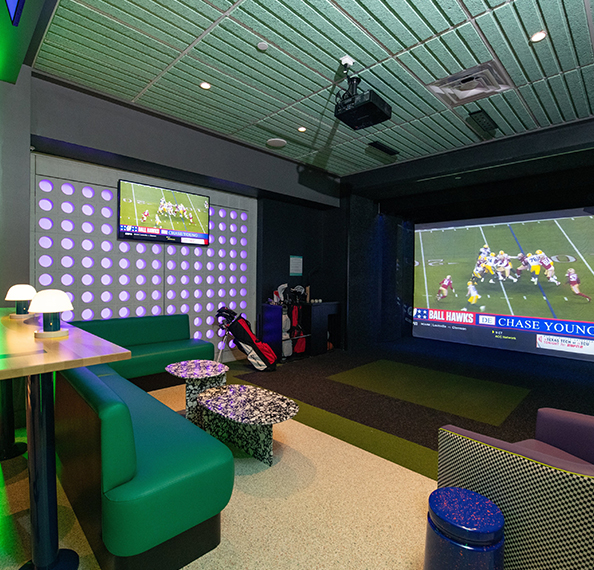 a room with a television and a large screen