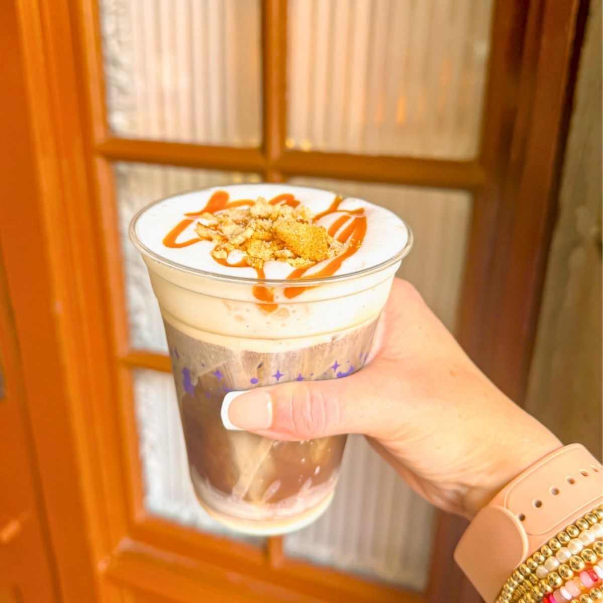 a hand holding a cup of coffee
