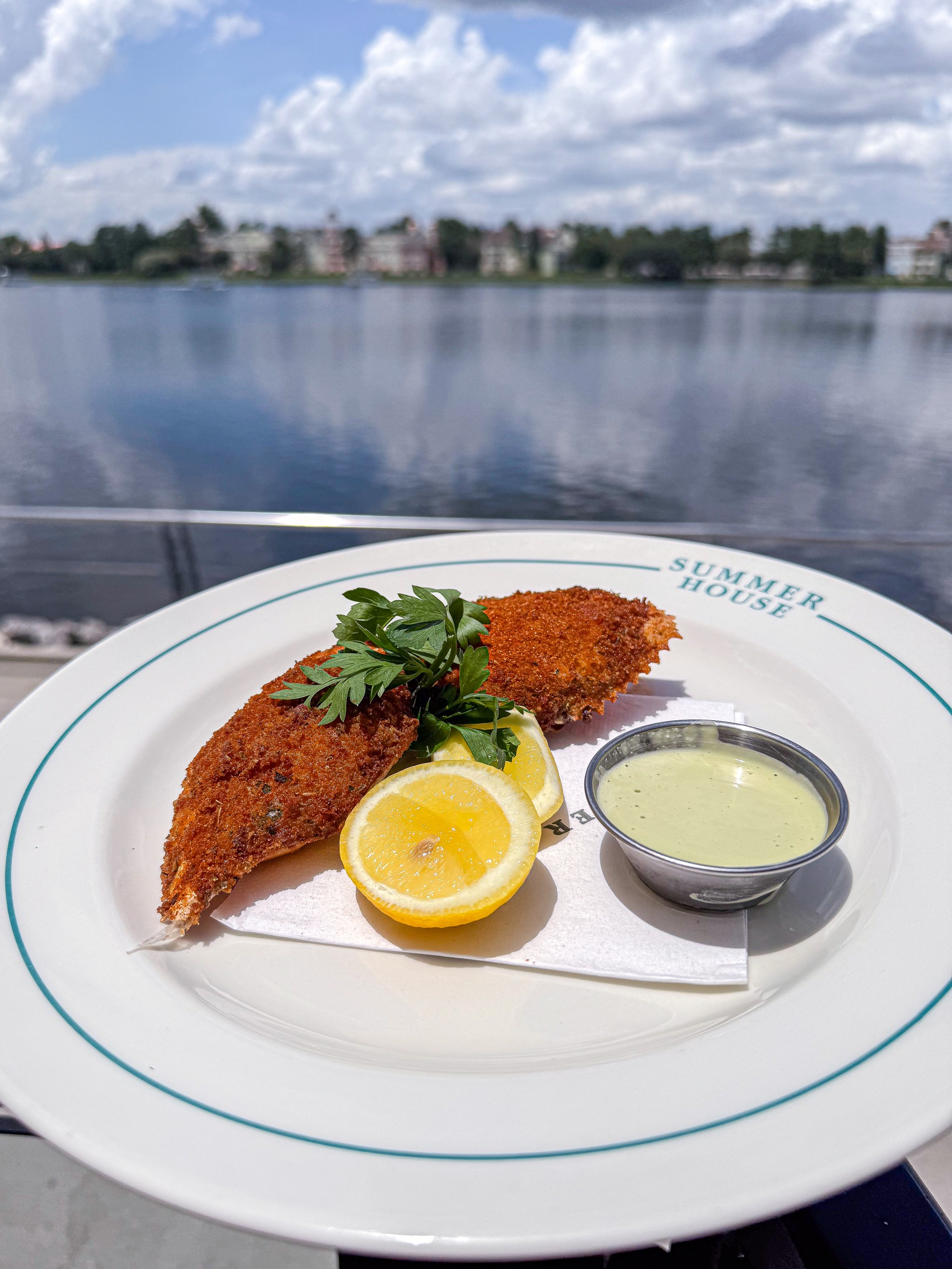 a plate of food with a side of lemon and sauce