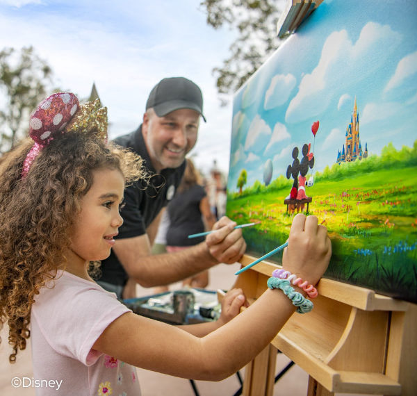 a girl painting on a canvas