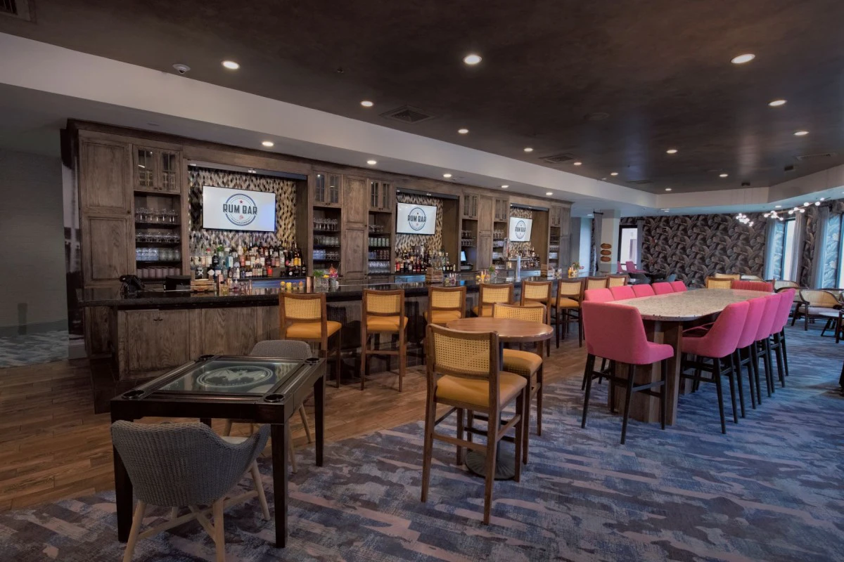 a room with a bar and chairs
