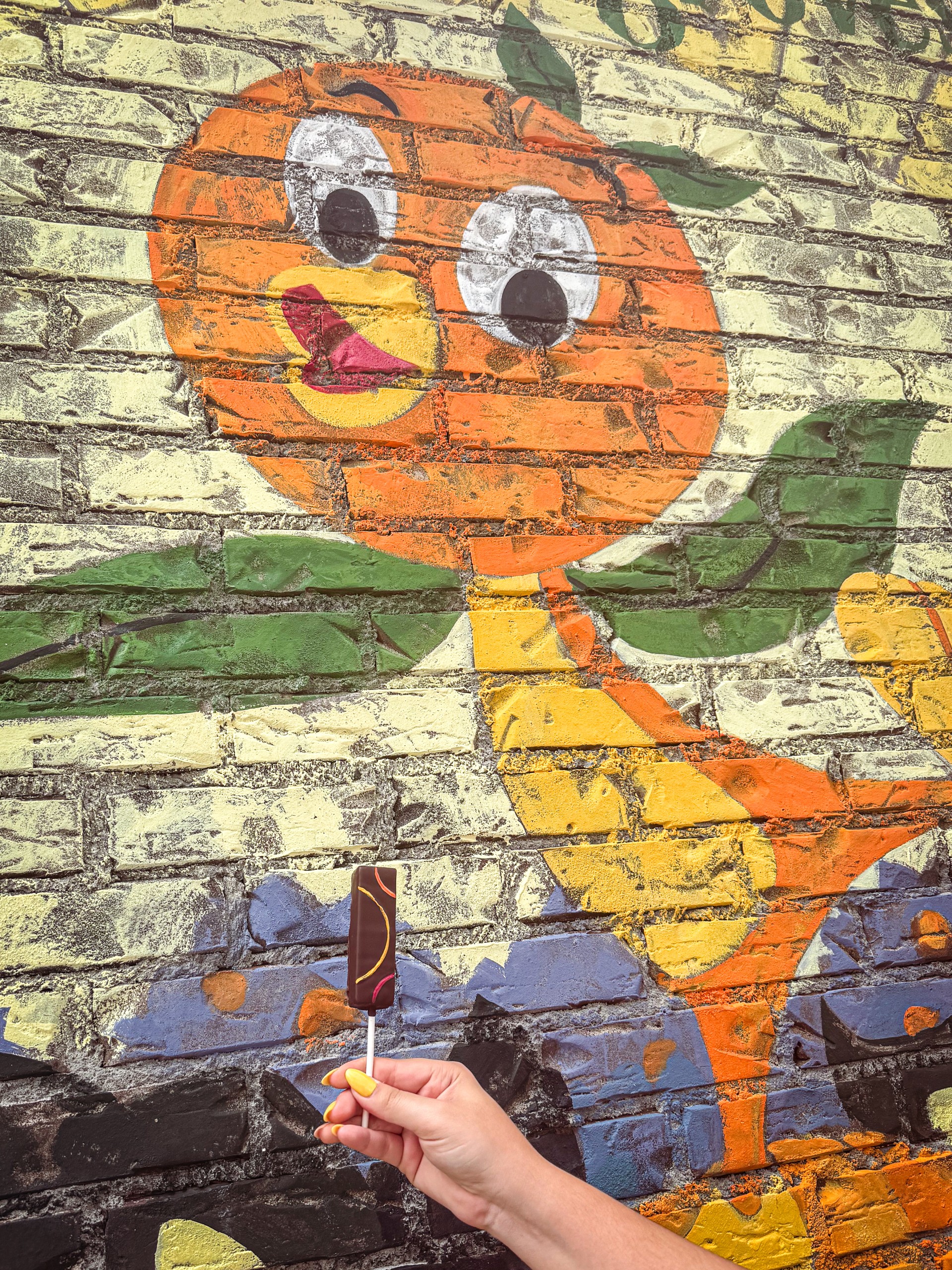 a hand holding a popsicle