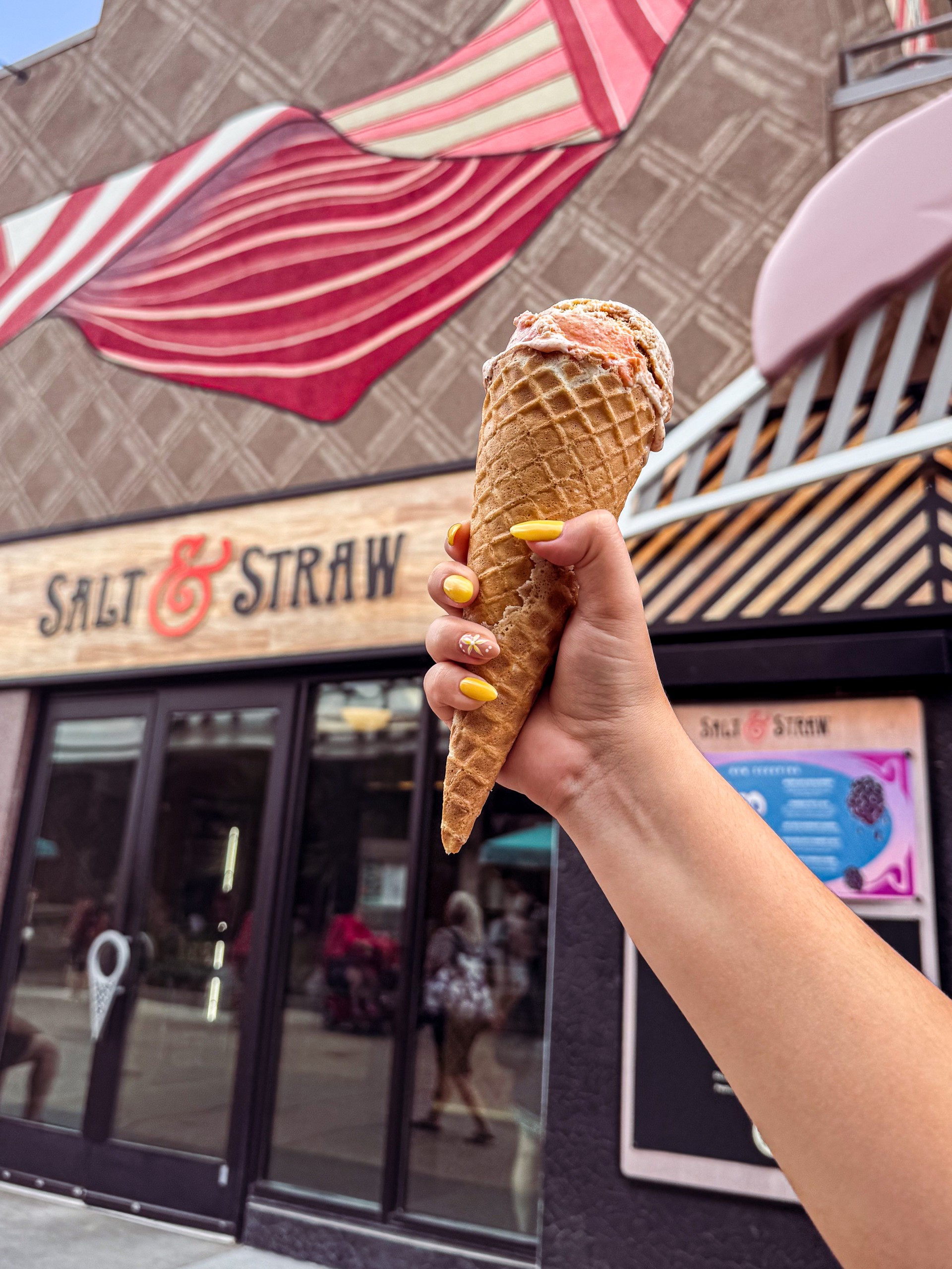 a hand holding an ice cream cone