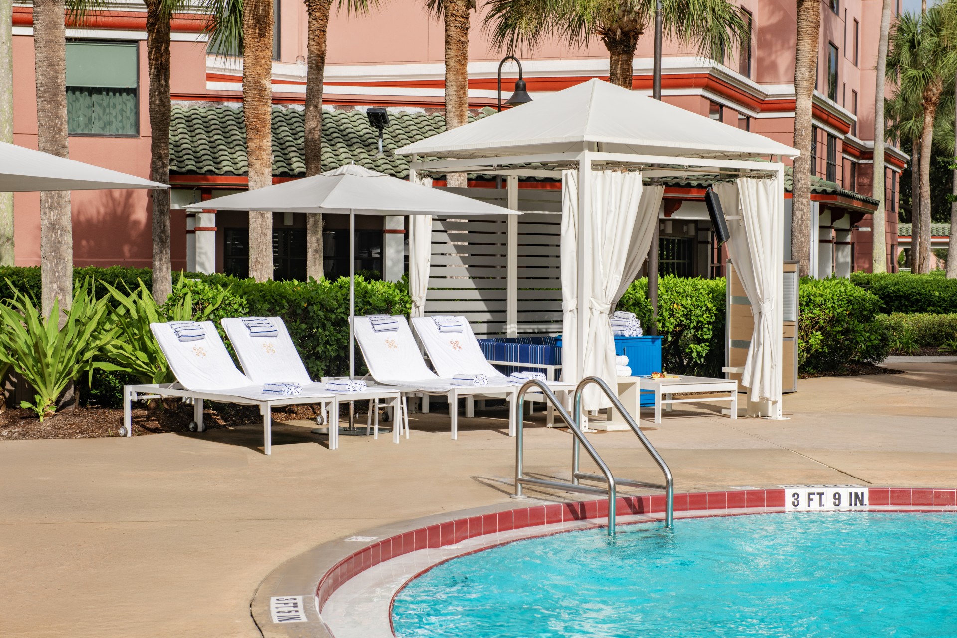 a pool with lounge chairs and umbrellas