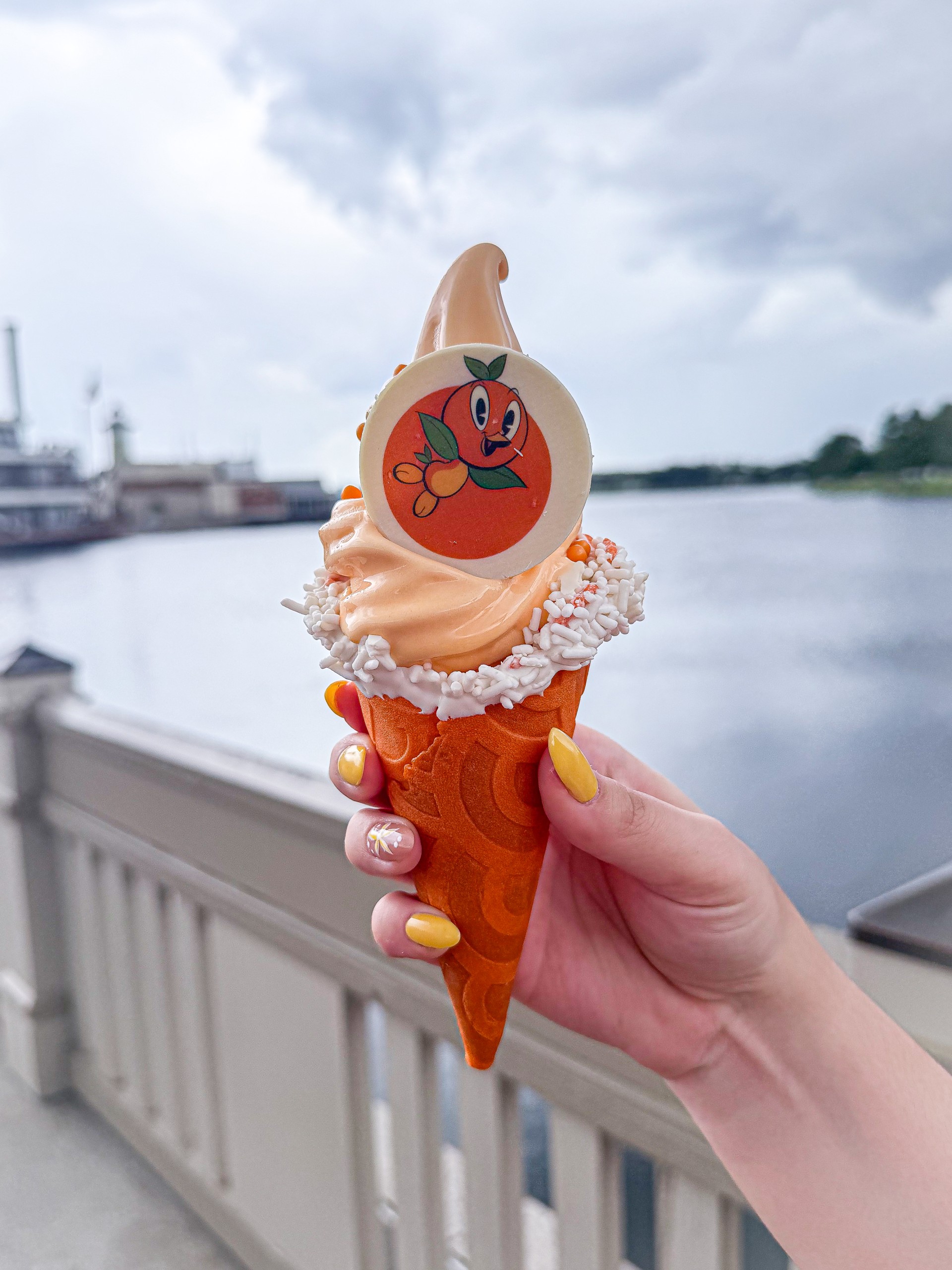 a hand holding an ice cream cone