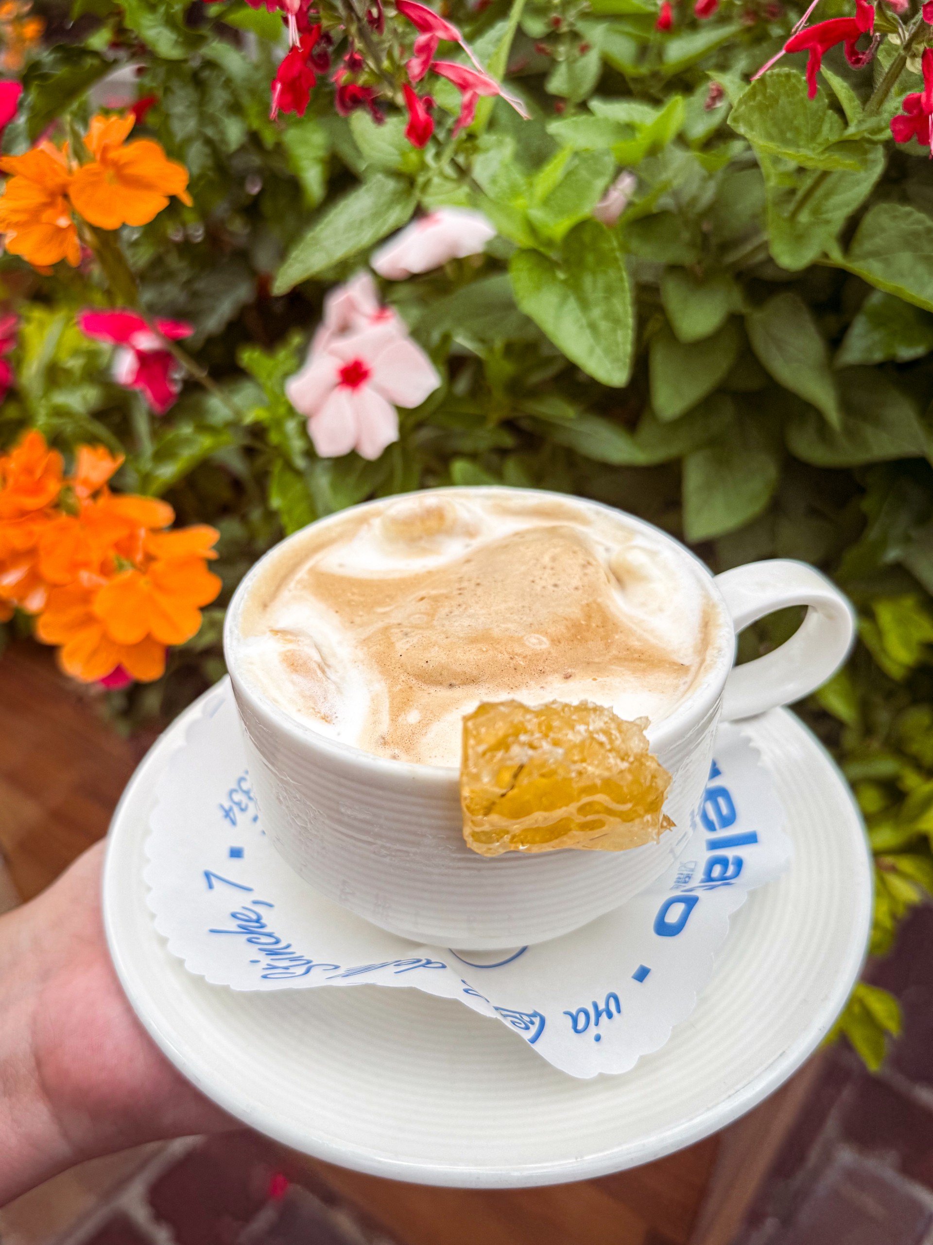 a hand holding a cup of coffee