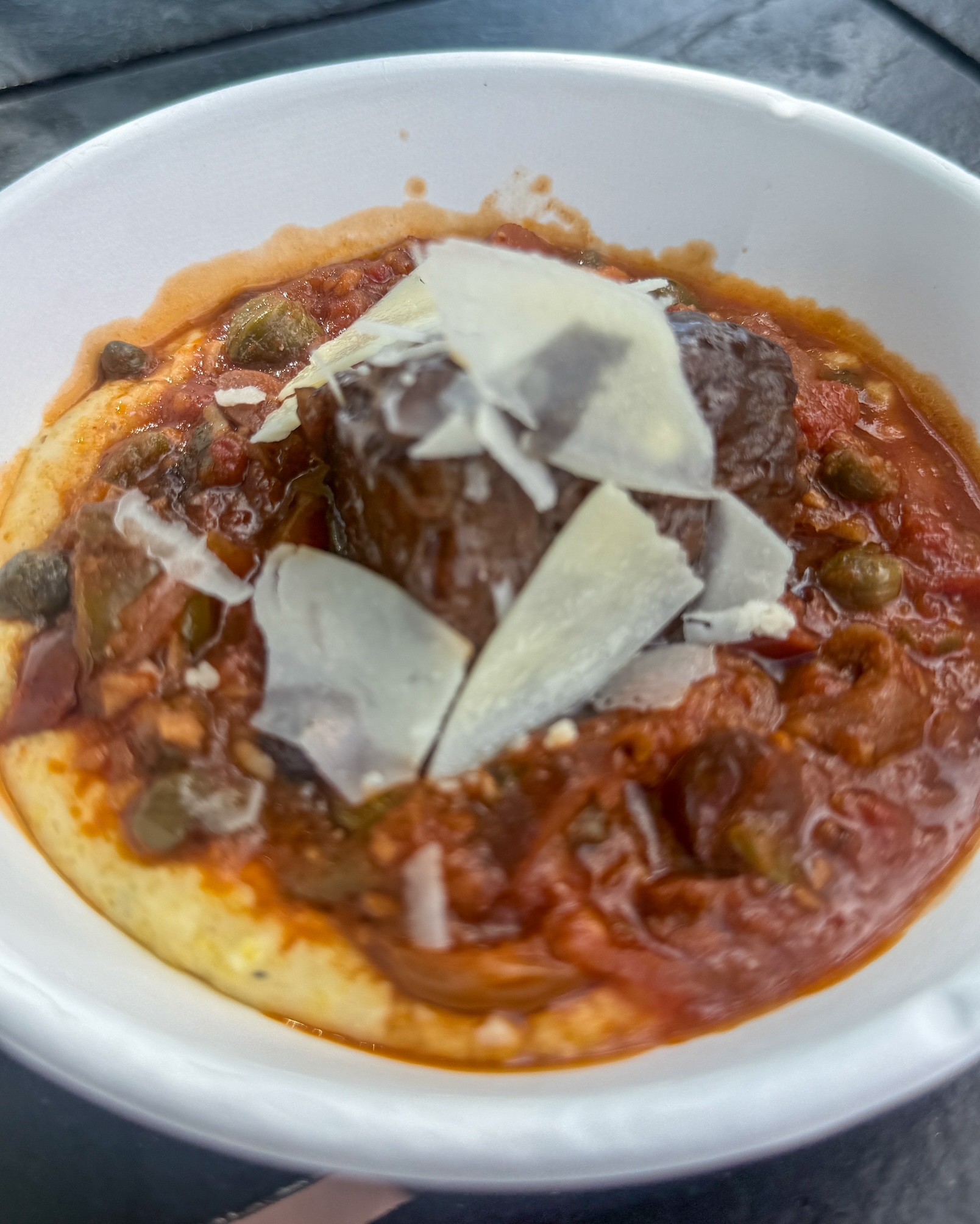 a bowl of food with meat and sauce