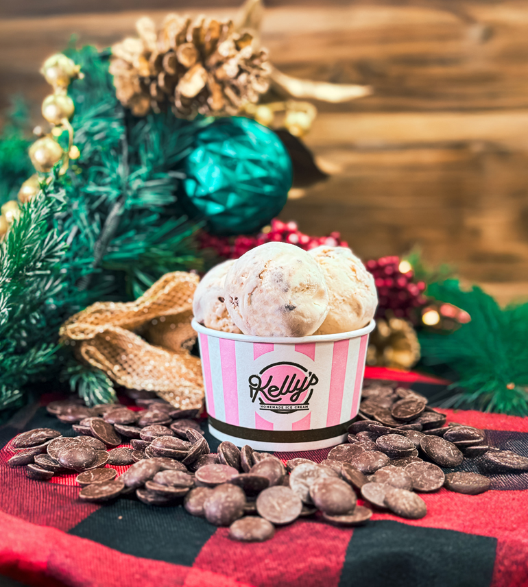 a cup of ice cream with chocolate chips and pine cones