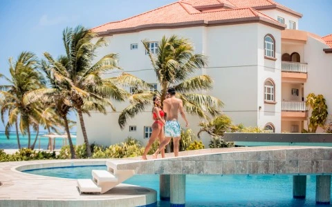a man and woman posing for a picture next to a pool