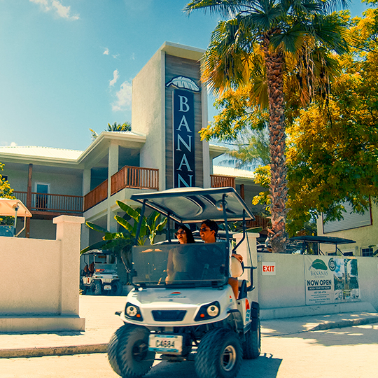 a couple of people driving a golf cart