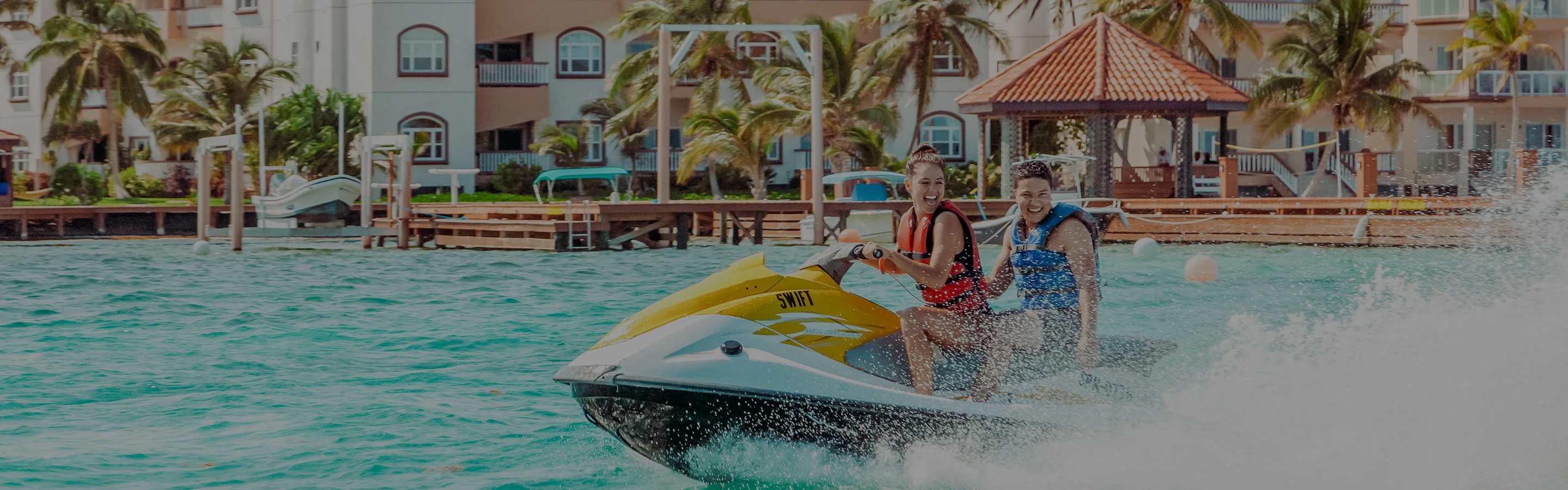 a couple of women on a jet ski in a pool