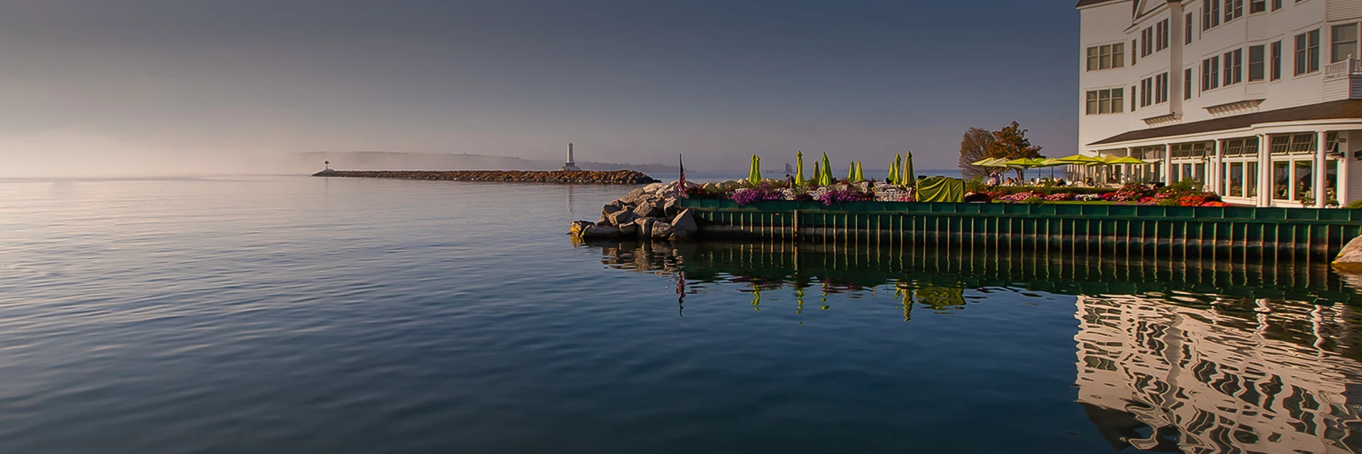 lake view of hotel Iroquois dock and outside patio during sunset