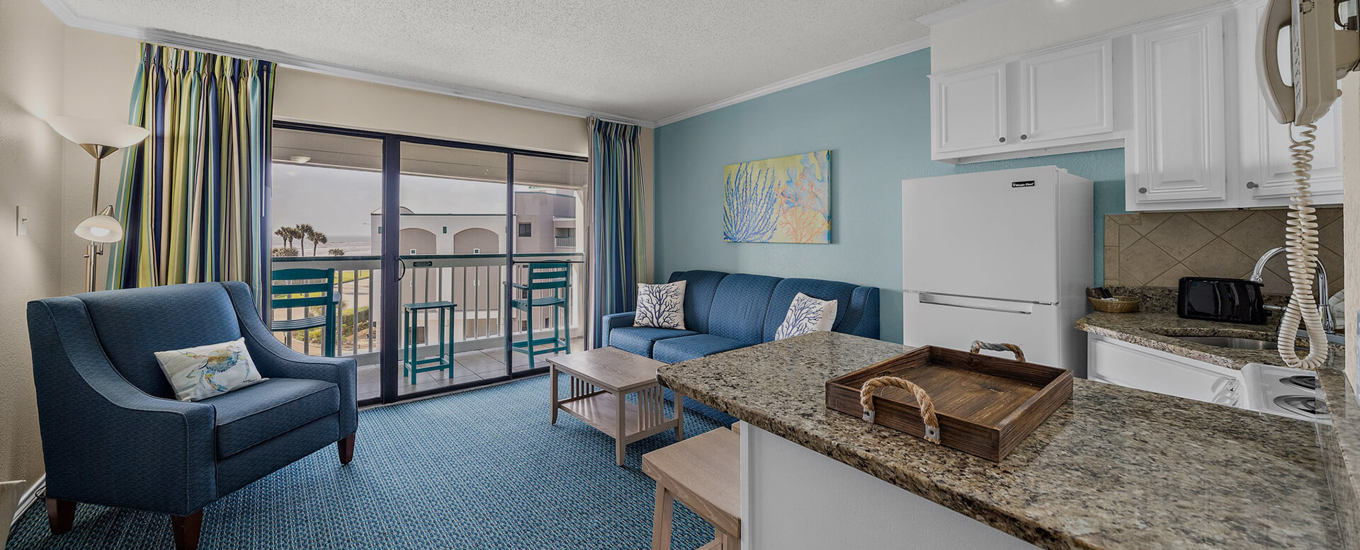 a living room with a blue couch and a marble counter top