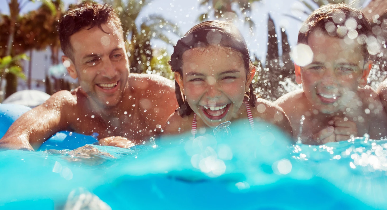 family in the pool laughing