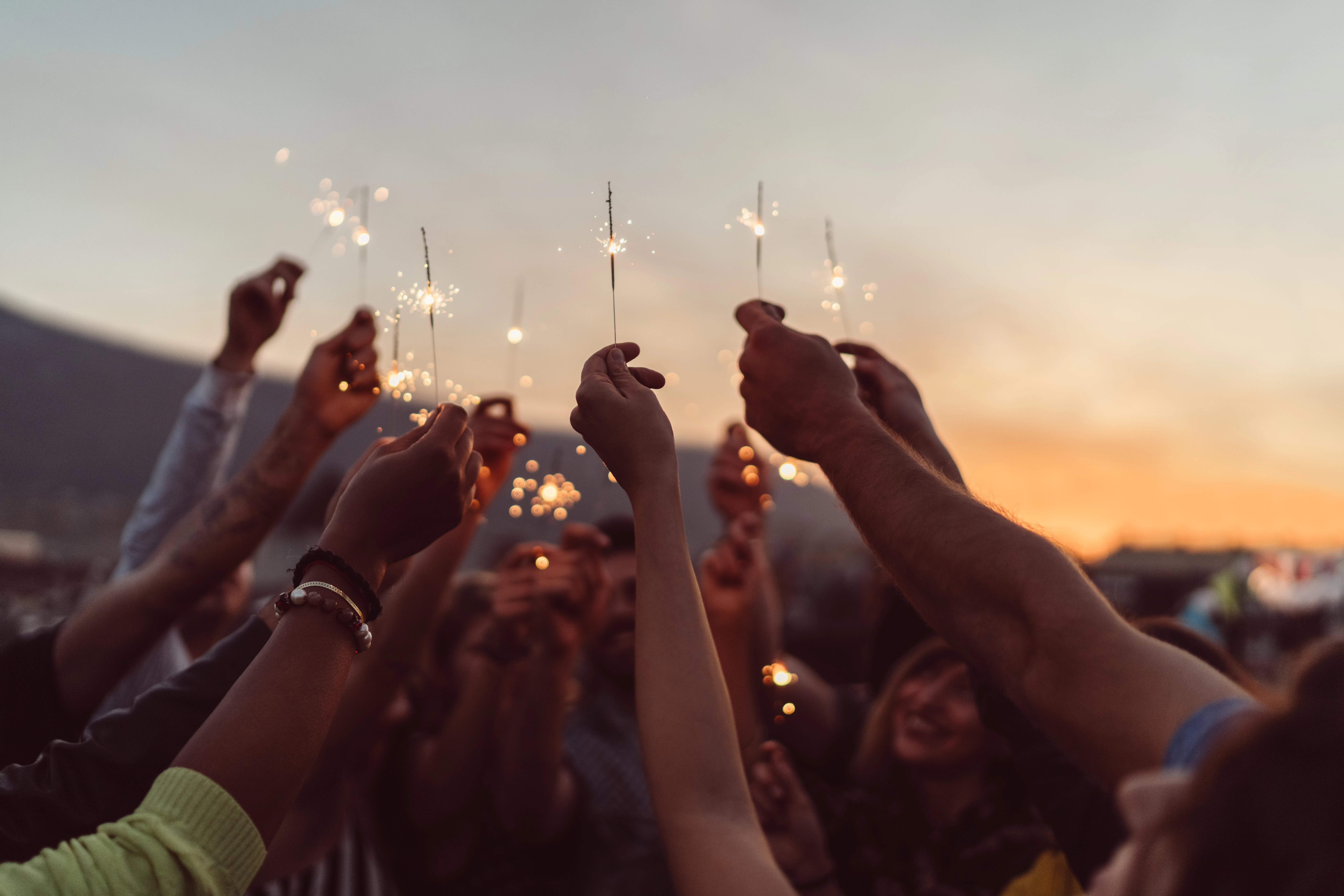 a group of people holding sparklers