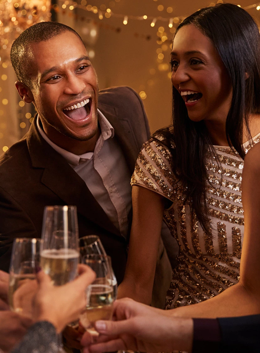 a man and woman holding glasses