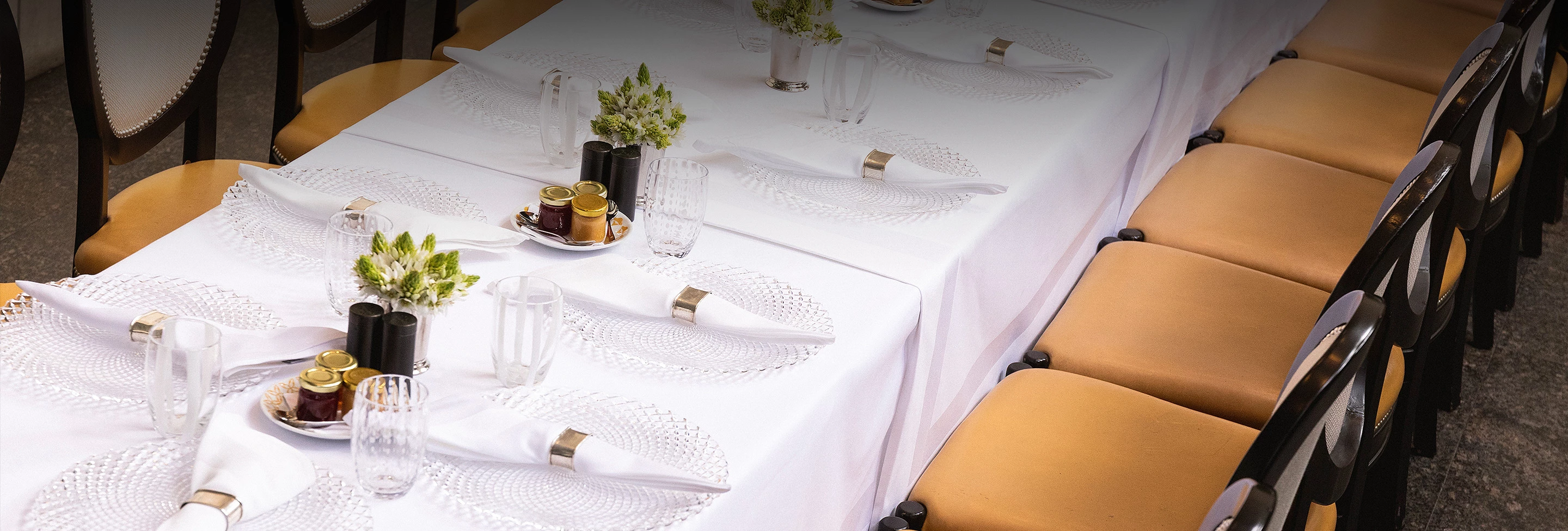 a table with place settings and chairs