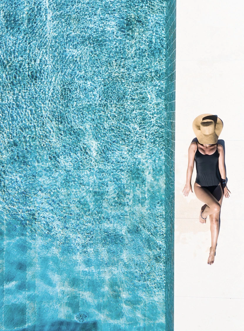 a person laying by a pool