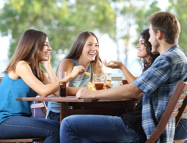 a group of people sitting at a table eating food