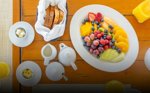 a plate of fruit and a bowl of bread
