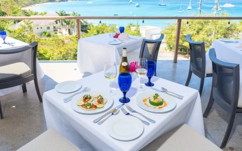 a table with plates and glasses on it and a bottle of wine on it