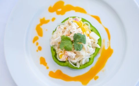 a green bell pepper with a salad on top