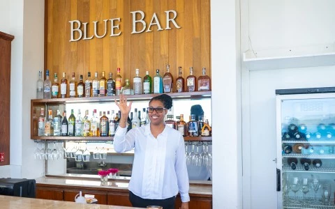 a woman standing in front of a bar
