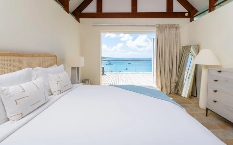 a bed with a view of the ocean from the window
