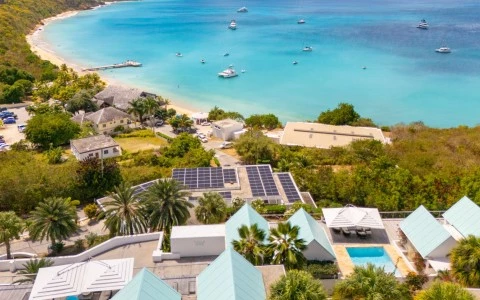 a aerial view of a beach with boats and buildings