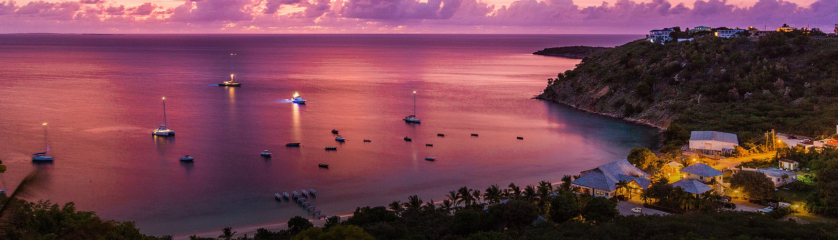 a body of water with boats in it and buildings around it