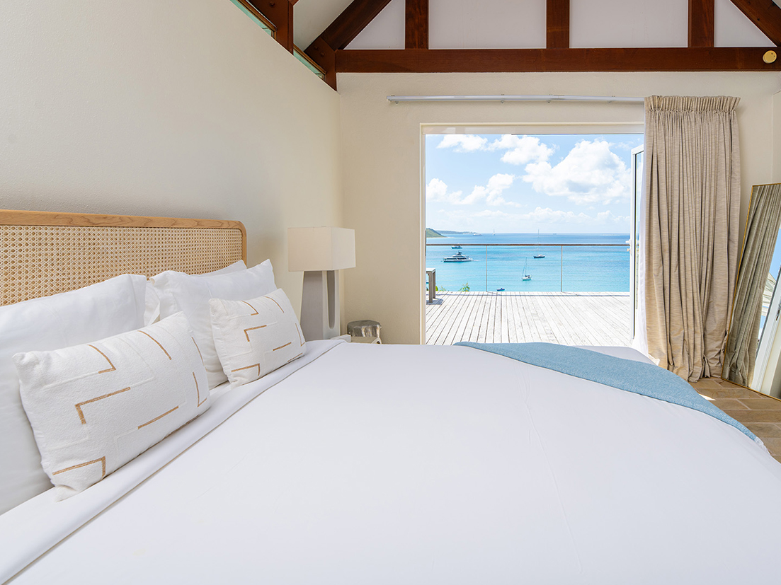 a bed with a view of the ocean