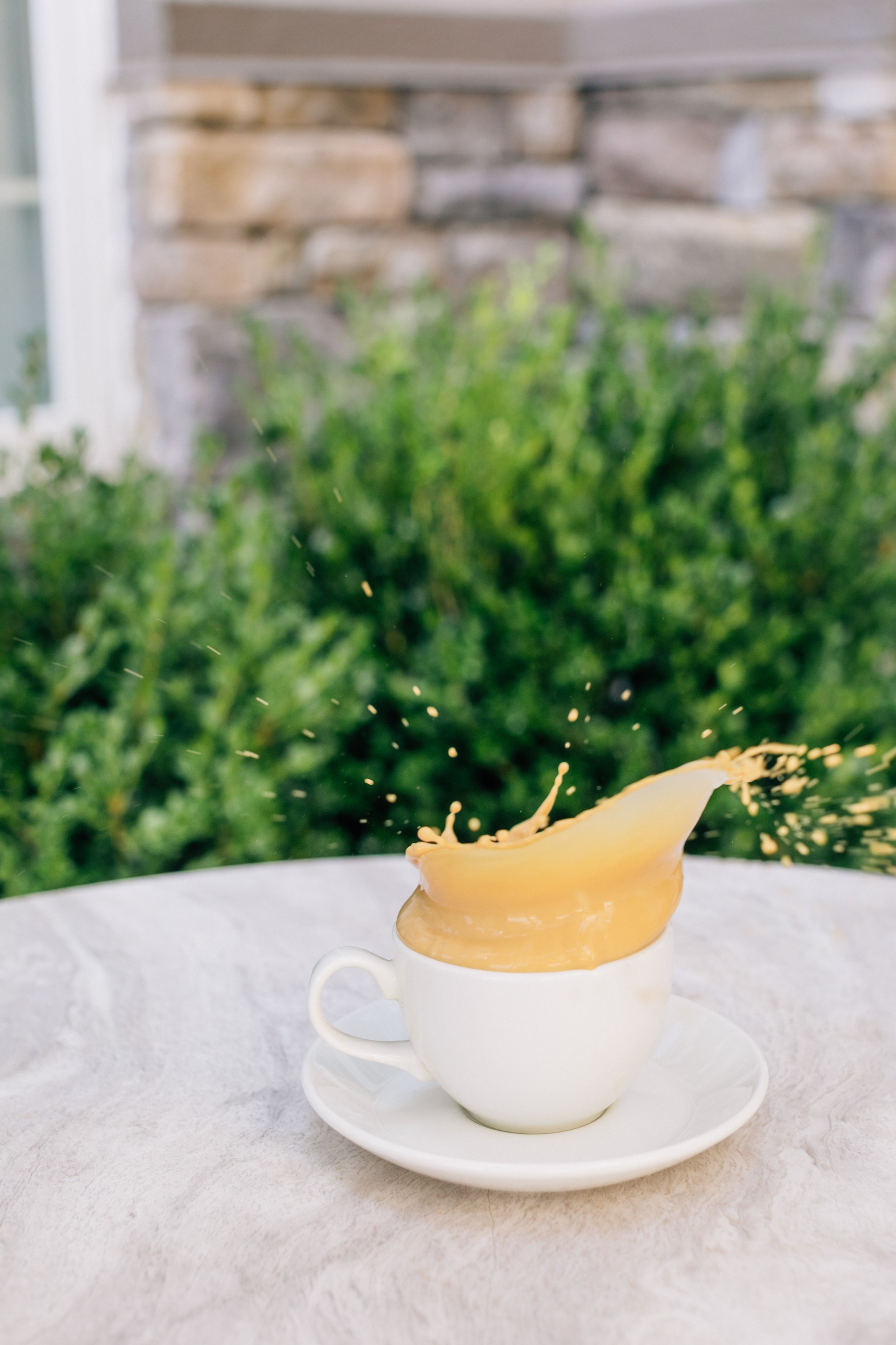 a cup of coffee splashing out of it