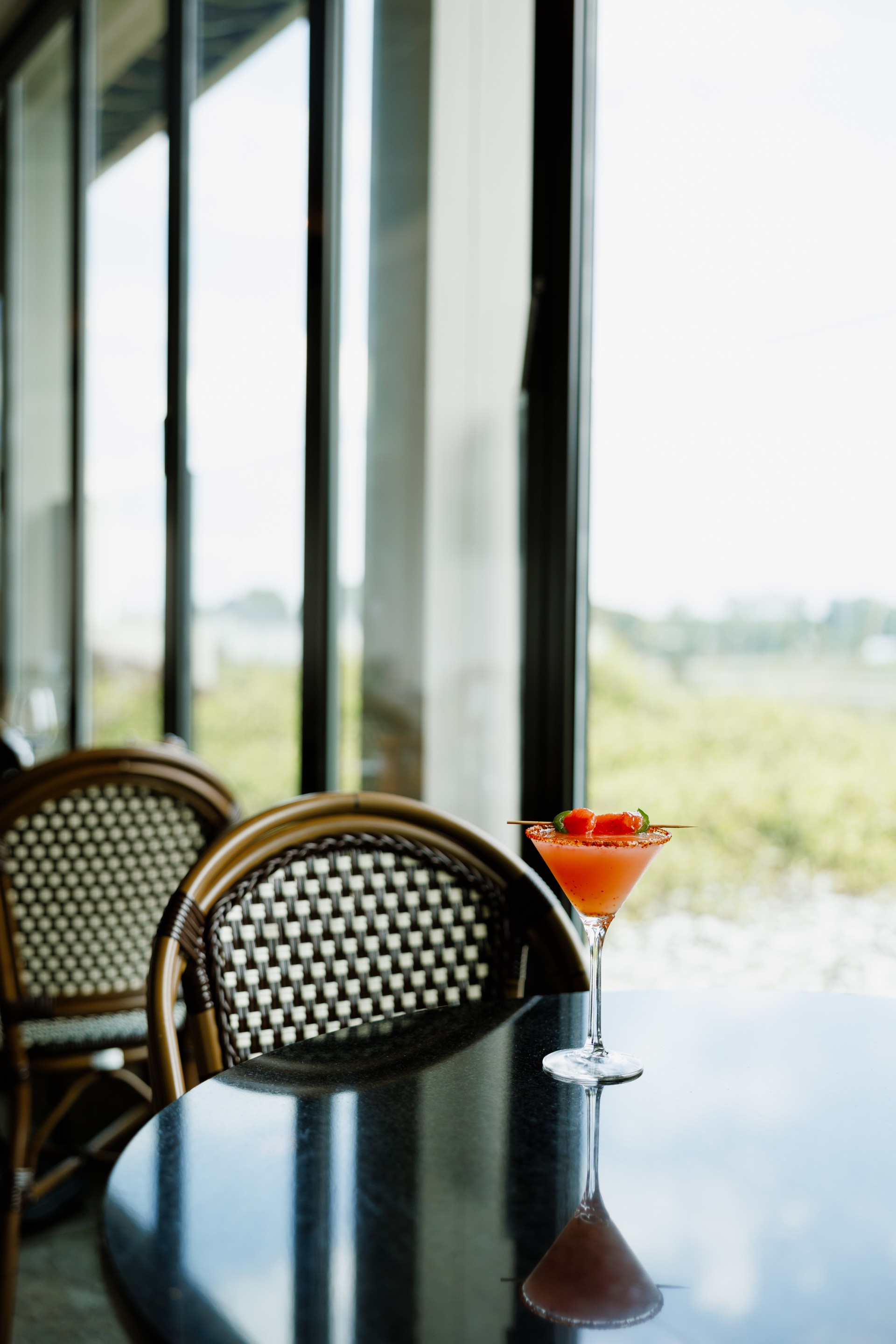 a glass of orange liquid on a table