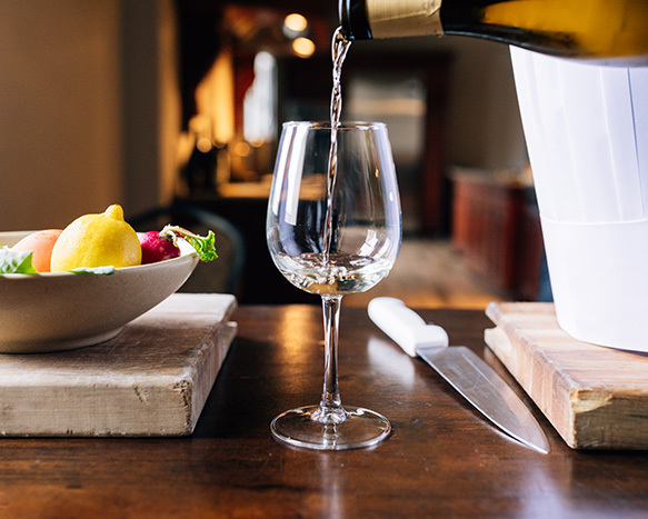 white wine being poured into a wine glass