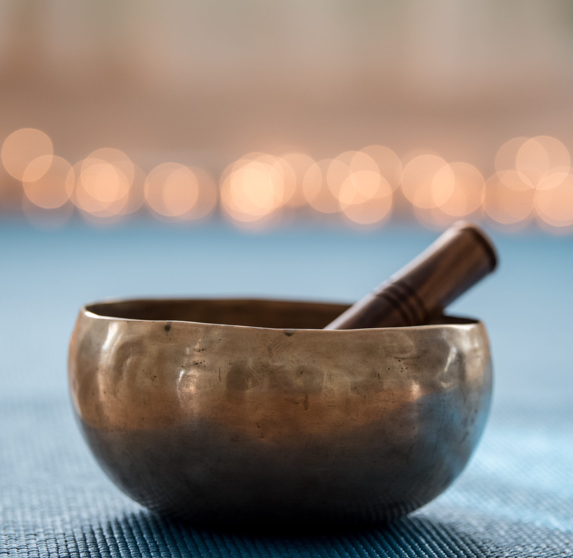 a small metal bowl with a stick