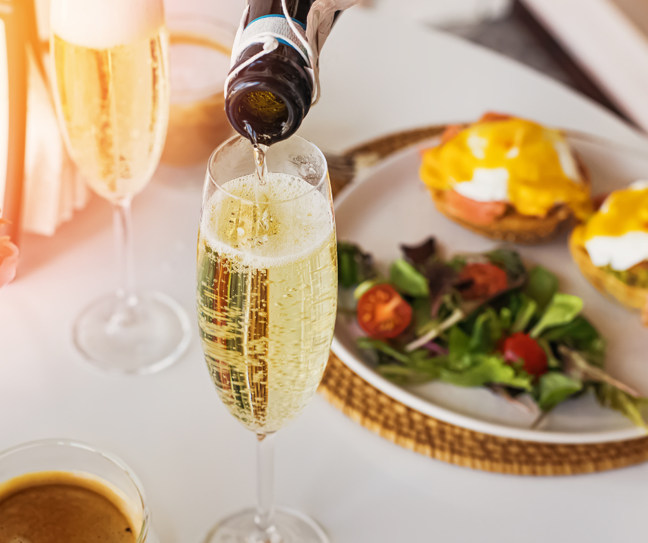 a person pouring champagne into a glass