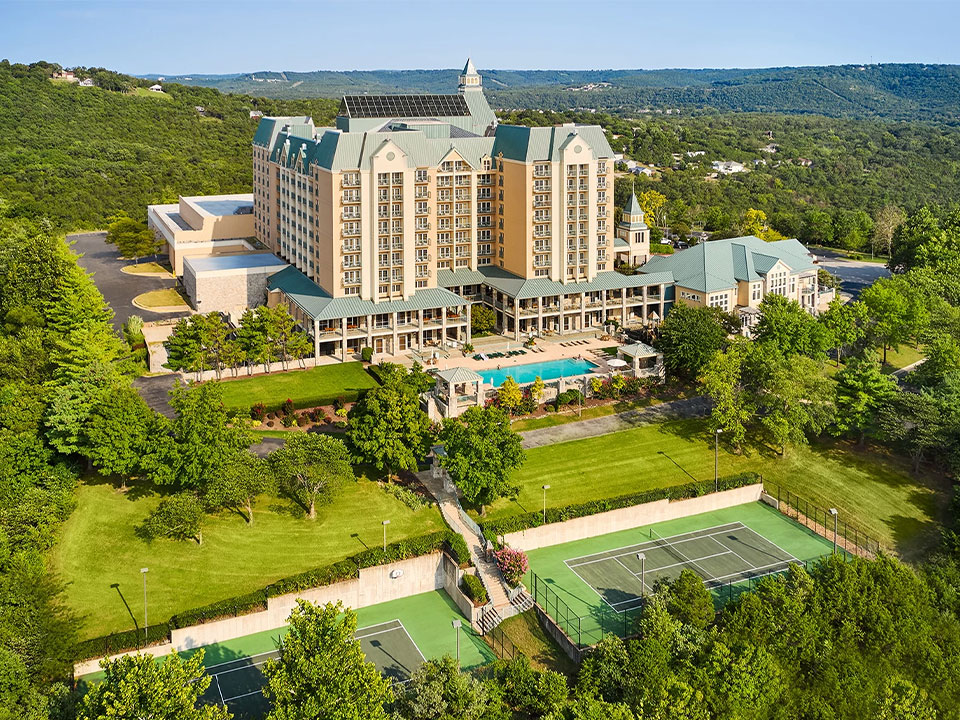 a large building with a tennis court and a tennis court