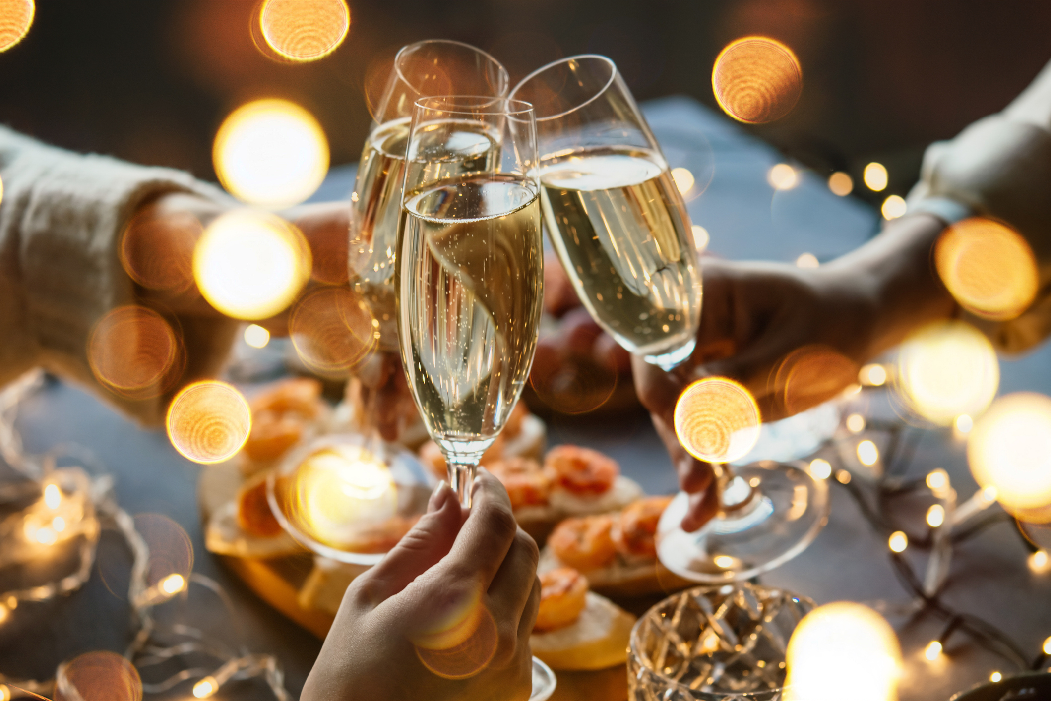 a group of people holding champagne glasses
