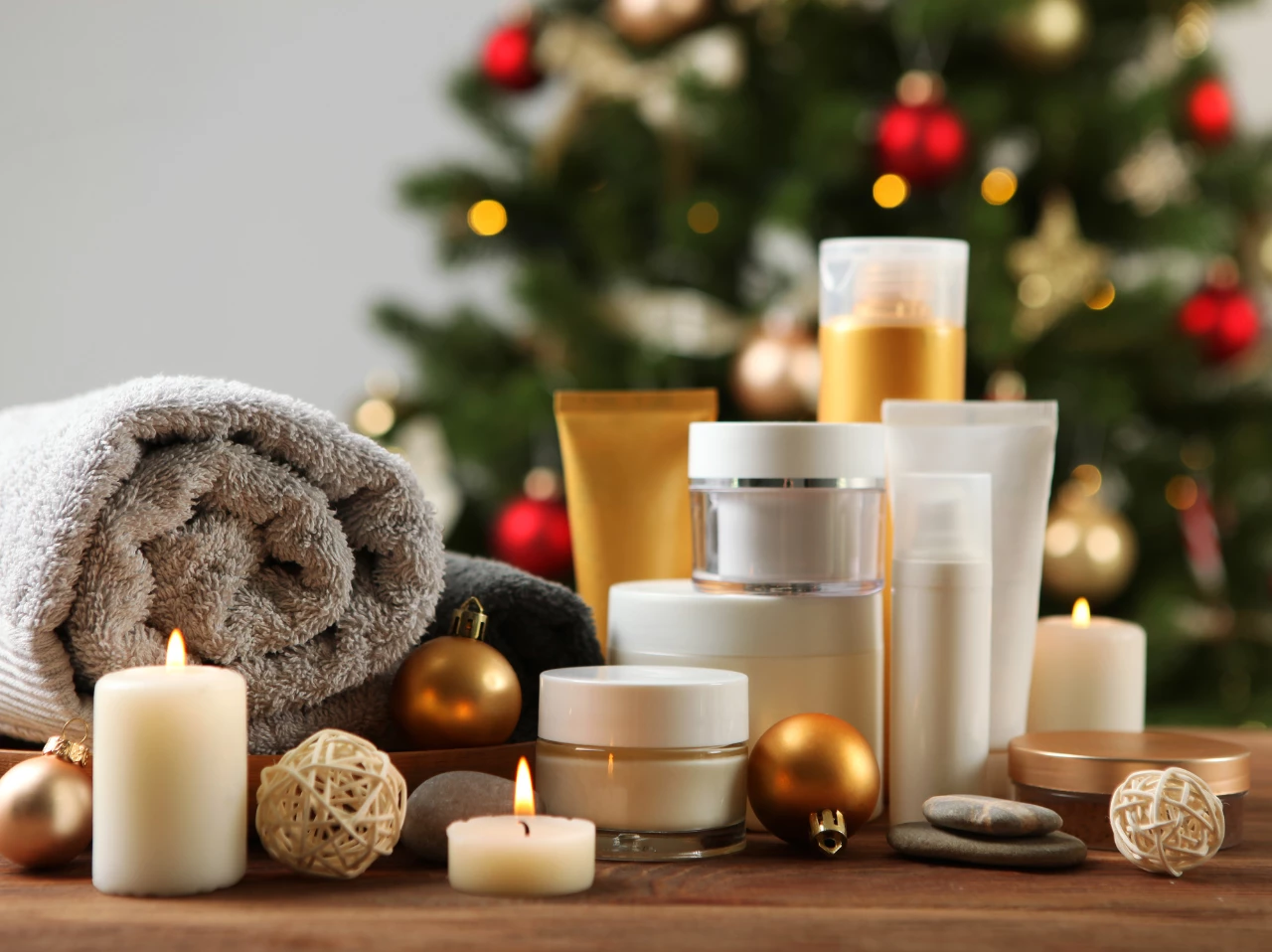a group of white containers and candles next to a towel