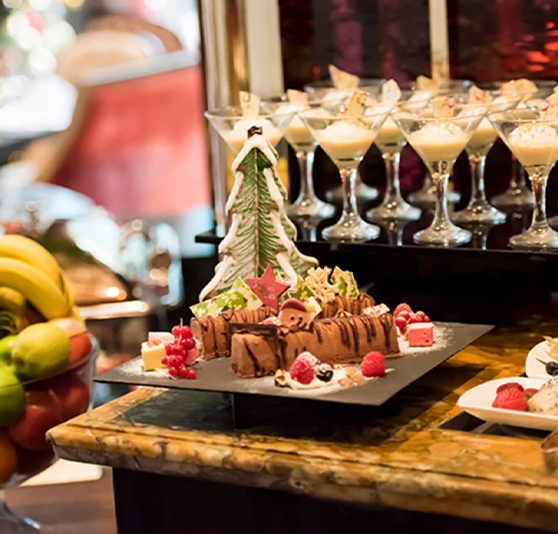 a table with desserts and glasses of fruit