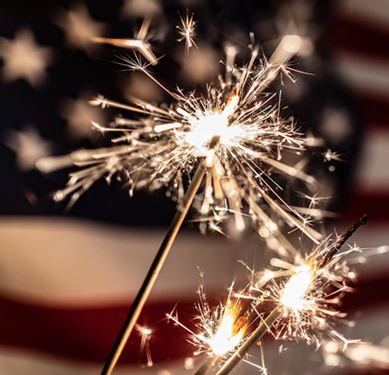 sparkles in front of a flag