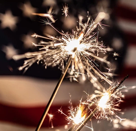sparkles in front of a flag