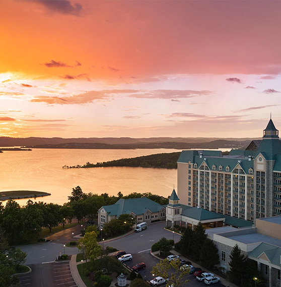 a large building with a body of water in the background