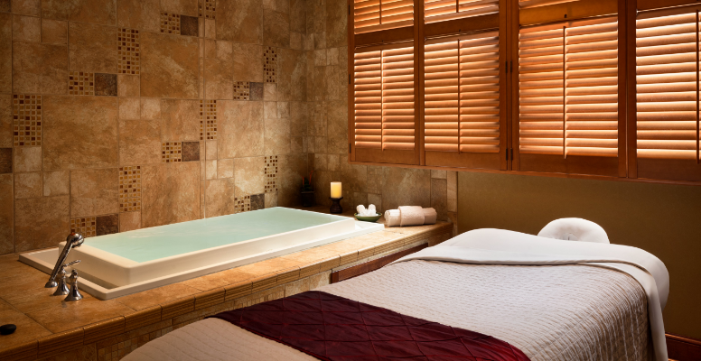 a room with two beds and a bathtub